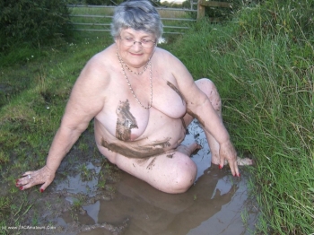 Fat pig grandma in the mud